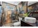 Modern bathroom featuring slate tile, vessel sink, and walk-in shower with glass door at 1734 8Th St, Atlanta, GA 30341