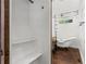 Stylish bathroom featuring a clawfoot tub, dark wood floors, and a separate closet for storage at 1734 8Th St, Atlanta, GA 30341