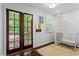 Cozy Bedroom features a crib, a patterned rug, and double doors that open to the outdoors at 1734 8Th St, Atlanta, GA 30341