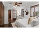 Well-lit bedroom with dark wood floors, ceiling fan, and a decorative mirror above the bed at 1734 8Th St, Atlanta, GA 30341
