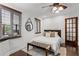 Bright bedroom with a geometric rug, dark wood floors, and a statement mirror over the headboard at 1734 8Th St, Atlanta, GA 30341