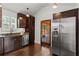 Bright kitchen with stainless steel refrigerator, dark cabinets, and wooden floor, with access to the deck at 1734 8Th St, Atlanta, GA 30341