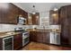 Modern kitchen with stainless steel appliances, granite countertops, wood floors, and stylish cabinetry at 1734 8Th St, Atlanta, GA 30341