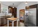 Bright kitchen with stainless steel refrigerator, dark cabinets, wooden floor, and central butcher block island at 1734 8Th St, Atlanta, GA 30341