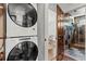 Convenient laundry area with stacked washer and dryer, and access to a modern bathroom at 1734 8Th St, Atlanta, GA 30341