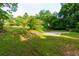 Expansive backyard featuring lush greenery and a basketball court, perfect for outdoor activities and recreation at 2024 Lower Burris Road Rd, Canton, GA 30114