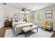This bedroom offers a ceiling fan, neutral paint, wood floors, and two windows for natural light at 2024 Lower Burris Road Rd, Canton, GA 30114