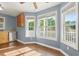 Bright breakfast nook features large windows with wooded views, wood floors, and ample sunlight at 2024 Lower Burris Road Rd, Canton, GA 30114