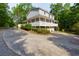Charming two-story home features a wraparound porch and a long driveway, perfect for enjoying the outdoors at 2024 Lower Burris Road Rd, Canton, GA 30114