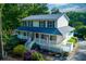 Charming two-story home featuring a spacious wrap-around porch and a well-maintained yard in a wooded setting at 2024 Lower Burris Road Rd, Canton, GA 30114