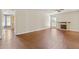 Spacious living room featuring hardwood floors, a fireplace, and plenty of natural light from the large windows at 2024 Lower Burris Road Rd, Canton, GA 30114