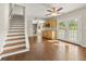 Open-concept living area with hardwood floors, ceiling fan, stairs and access to the deck through the French doors at 2024 Lower Burris Road Rd, Canton, GA 30114