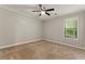 Cozy bedroom with soft carpeting, a ceiling fan, and a window for natural light, providing a tranquil space at 2041 Kramer Way, Marietta, GA 30062