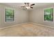 Comfortable bedroom with ample natural light, a ceiling fan, and soft carpeting for a cozy atmosphere at 2041 Kramer Way, Marietta, GA 30062