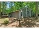 Exterior of a home featuring light-colored siding, a chimney, white framed windows, and a wooded lot at 2041 Kramer Way, Marietta, GA 30062