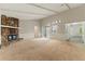 Spacious living room features a stone fireplace, sliding glass doors, and neutral carpeting for a cozy and inviting atmosphere at 2041 Kramer Way, Marietta, GA 30062
