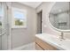 Contemporary bathroom featuring a sleek vanity, round mirror, and glass-enclosed shower with marble tile at 2872 Estuary Dr, Acworth, GA 30101