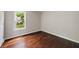 Comfortable bedroom with dark wood floors and a window overlooking the backyard at 2872 Estuary Dr, Acworth, GA 30101
