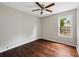 Cozy bedroom featuring dark wood floors and a bright window with a view of the neighborhood at 2872 Estuary Dr, Acworth, GA 30101