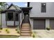 Home exterior featuring a gabled facade, front porch stairs, bay window, and a two-car garage at 2872 Estuary Dr, Acworth, GA 30101