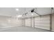 Spacious garage with two automatic doors and bright lighting, offering ample room for vehicles and storage at 2872 Estuary Dr, Acworth, GA 30101