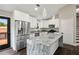 Modern kitchen with white cabinetry, granite countertops, stainless steel appliances, and a large island at 2872 Estuary Dr, Acworth, GA 30101
