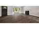 Open living room with dark wood floors, a fireplace, and an entrance door at 2872 Estuary Dr, Acworth, GA 30101