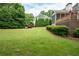 Lush green backyard with a patio, deck, and well-manicured landscaping at 3361 Woodington Se Ct, Marietta, GA 30067