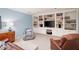 Spacious basement with built in shelving, cabinetry, and a comfortable seating area at 3361 Woodington Se Ct, Marietta, GA 30067