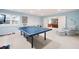 Finished basement featuring a ping pong table, and a comfortable seating area for recreation at 3361 Woodington Se Ct, Marietta, GA 30067