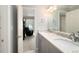 Bathroom boasts double sinks with granite counters, modern fixtures, and open-concept access to a bedroom at 3361 Woodington Se Ct, Marietta, GA 30067