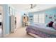 Comfortable bedroom featuring bright blue walls, ceiling fan, and shuttered windows at 3361 Woodington Se Ct, Marietta, GA 30067