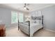Serene bedroom with a decorative iron bed frame, soft gray walls, and large window at 3361 Woodington Se Ct, Marietta, GA 30067