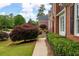 A well-manicured lawn and vibrant landscaping accent the brick home's exterior at 3361 Woodington Se Ct, Marietta, GA 30067