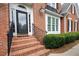 Brick steps lead to the detailed front door, framed by lush landscaping at 3361 Woodington Se Ct, Marietta, GA 30067