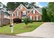Beautiful red brick home with a manicured lawn and driveway providing great curb appeal at 3361 Woodington Se Ct, Marietta, GA 30067