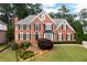 Imposing brick two-story home with manicured lawns, mature shrubs and handsome landscaping at 3361 Woodington Se Ct, Marietta, GA 30067