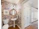 Charming half bathroom with unique wallpaper, pedestal sink, and hardwood floors at 3361 Woodington Se Ct, Marietta, GA 30067