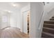 Entry hallway showcasing laminate flooring, closet storage, and stair access to the upper level at 3361 Woodington Se Ct, Marietta, GA 30067