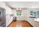 Well-lit kitchen featuring white cabinets, an eat-in island with gas cooktop, and a view to the backyard at 3361 Woodington Se Ct, Marietta, GA 30067