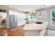 Bright kitchen with white cabinets, stainless steel appliances, and eat-in bar area overlooking the yard at 3361 Woodington Se Ct, Marietta, GA 30067