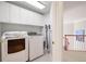 Bright laundry room featuring upper cabinets and modern washer and dryer at 3361 Woodington Se Ct, Marietta, GA 30067