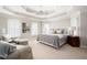 Spacious main bedroom offers tray ceilings, shuttered windows, and sitting area with plush chairs at 3361 Woodington Se Ct, Marietta, GA 30067