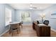 Comfortable home office offers natural light, stylish furniture, and a ceiling fan at 3361 Woodington Se Ct, Marietta, GA 30067