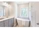 Relaxing bathroom showcasing a standalone tub and vanity with elegant design at 3810 Jack Vernon Cir, Powder Springs, GA 30127