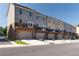 Back exterior shot of modern townhomes with garages and balcony on the second floor at 3810 Jack Vernon Cir, Powder Springs, GA 30127