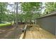 The spacious wood deck is built in the backyard and overlooks mature trees at 5807 Christopher Ln, Lithonia, GA 30058