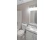 Neutral toned bathroom features a shower-tub combo, toilet, and vanity with a gray granite countertop at 5807 Christopher Ln, Lithonia, GA 30058