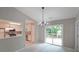 Bright dining room featuring backyard views, modern lighting and seamless access to the kitchen at 5807 Christopher Ln, Lithonia, GA 30058