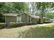 Ranch home featuring traditional styling, well-maintained landscaping and a symmetrical design at 5807 Christopher Ln, Lithonia, GA 30058
